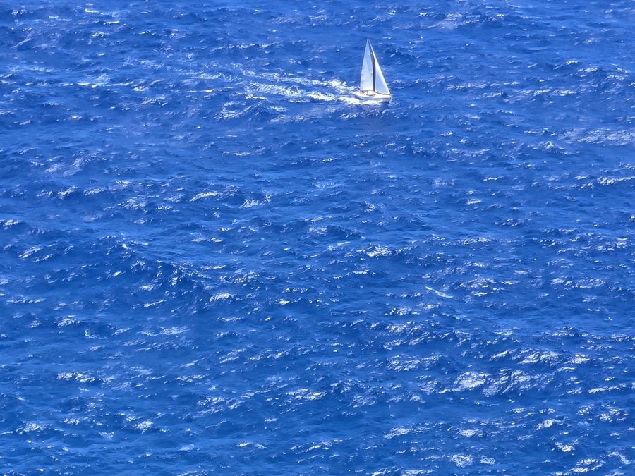 A sailboat on deep blue water off Oahu